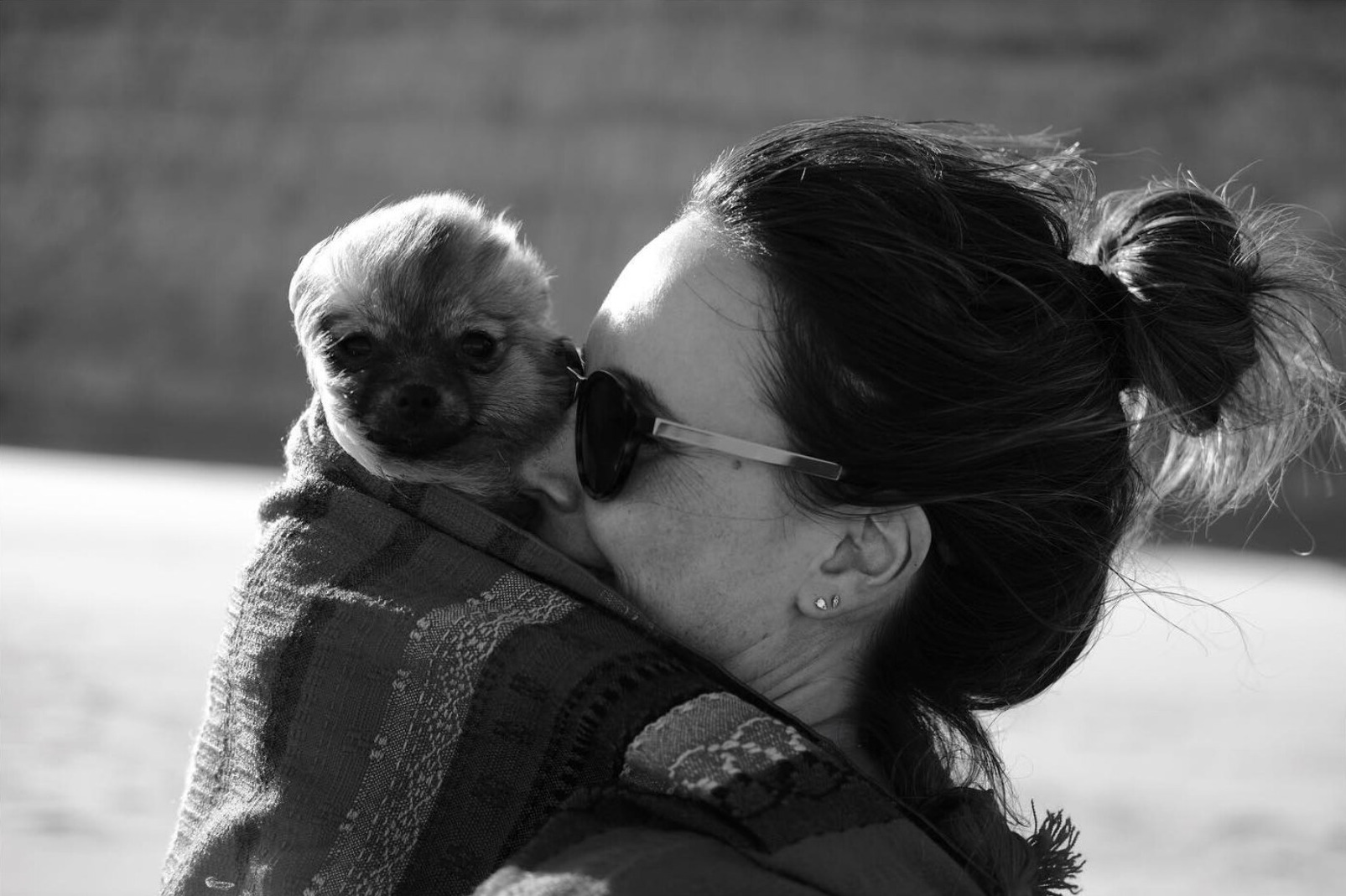 Black and white portrait of a woman holding a small dog